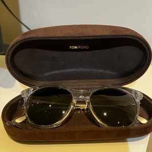 Tom Ford clear resin cat eye sunglasses with grey and blue lenses.